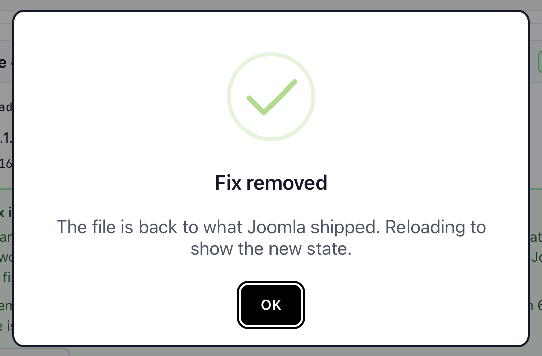 A confirmation dialog with a green tick, headed Fix removed, reading The file is back to what Joomla shipped. Reloading to show the new state.